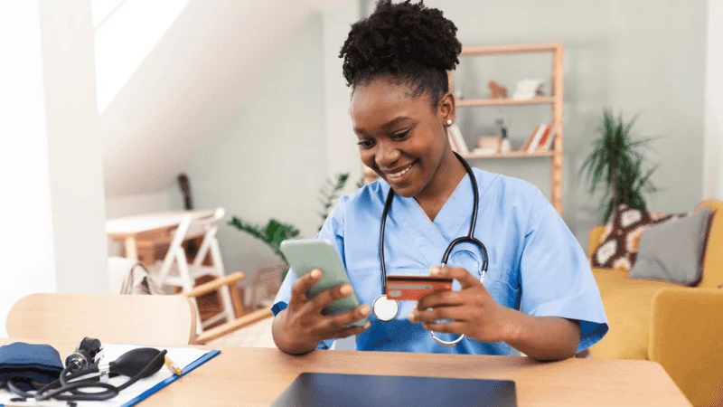 a nurse holding a credit card