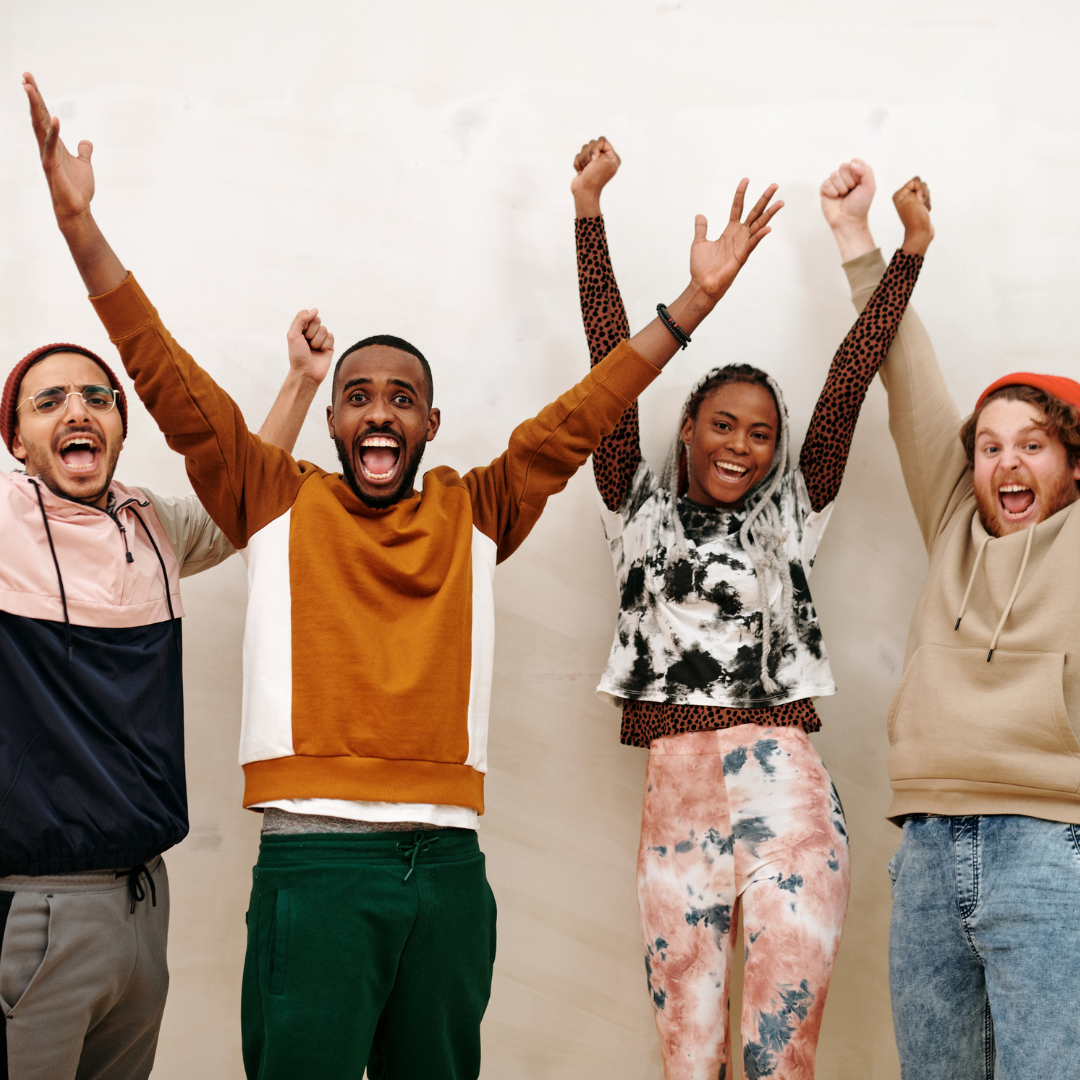 Happy people raising their hands